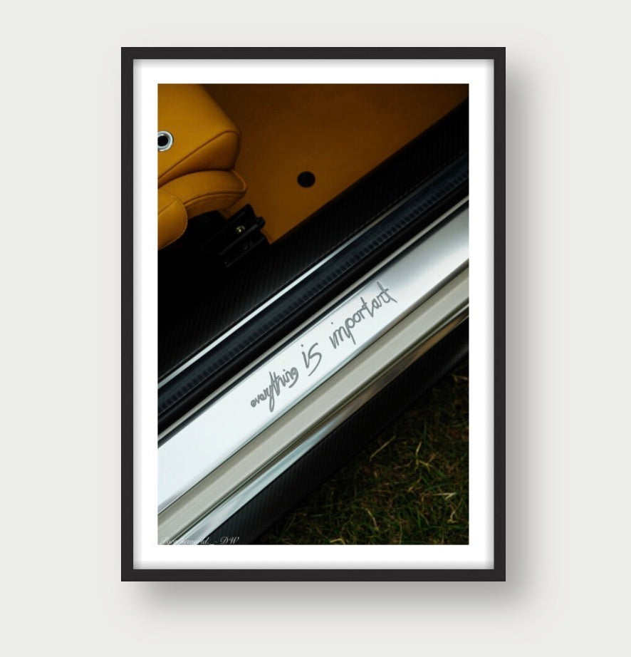 Framed automotive print with "everything is important" text on luxury car interior details